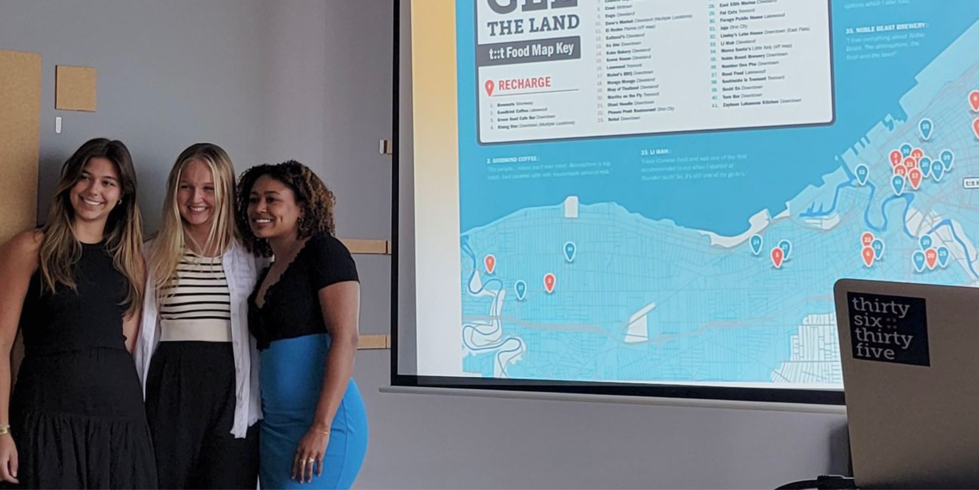 Kayley, Maddie and Mya standing in front of their map presentation