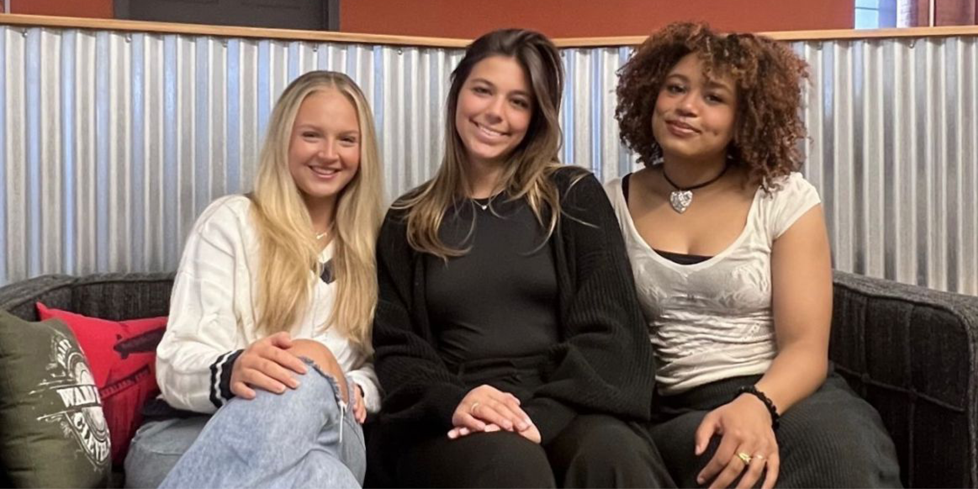 Maddie, Kayley and Mya sitting on a couch